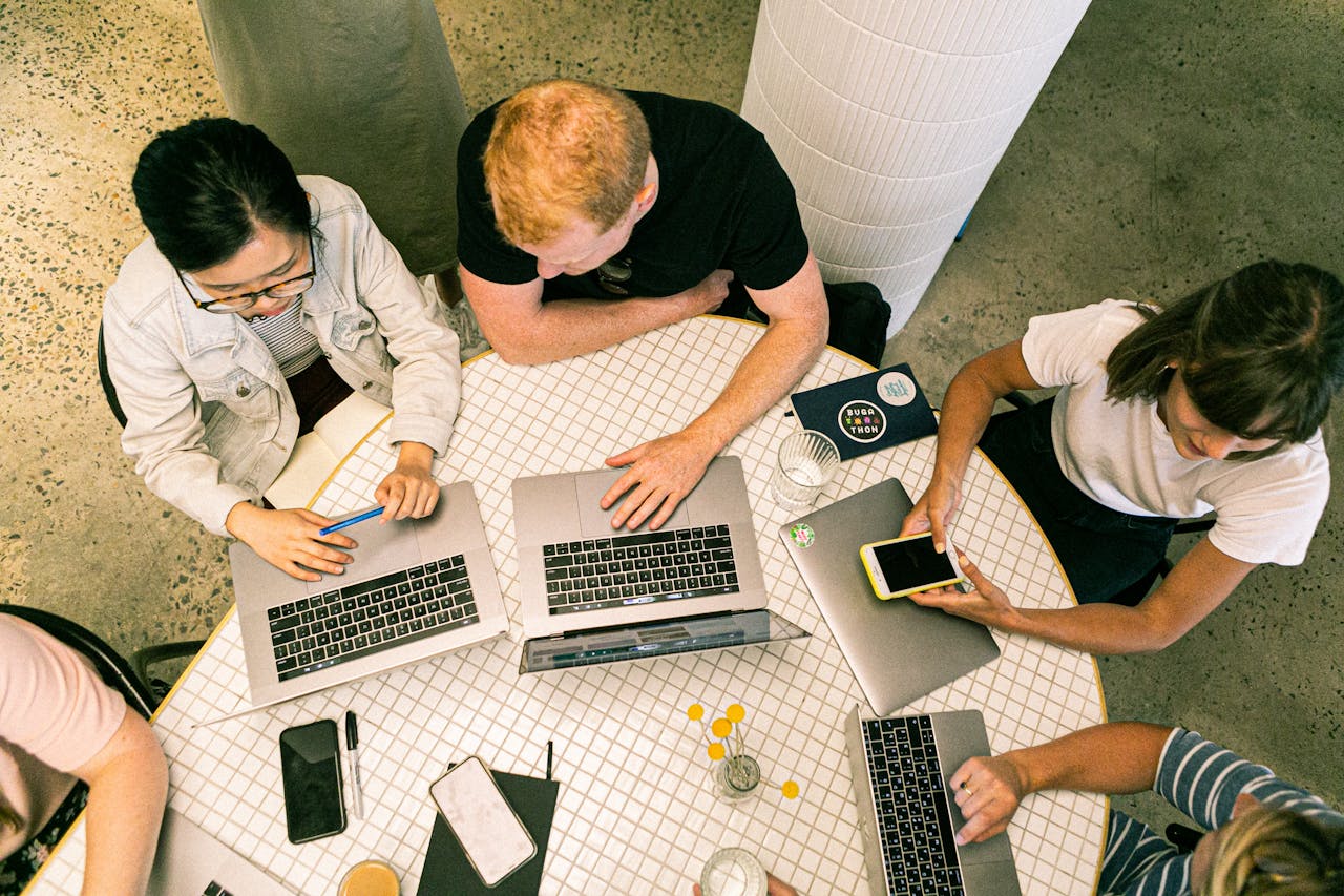 Top view of diverse team collaboratively working in a modern office setting.